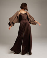 Model wearing a brown bolero over a brown outfit, showcasing the bolero's design.
