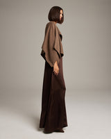 Model wearing a brown bolero over a long brown dress