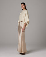 Model wearing an ivory alpaca crop top with a satin skirt