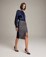 Model wearing Arrow Wrap Pencil Skirt in navy with a side slit and geometric design
