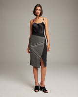Model wearing Arrow Wrap Pencil Skirt with a black top and heels, showcasing the skirt's design.