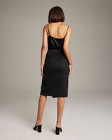 Model wearing a black Arrow Wrap Pencil Skirt from the back