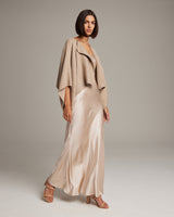 Model wearing a bolero in solid baby alpaca over a satin slipdress