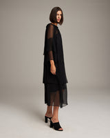 Model wearing a black Cascade Dress with layered chiffon design