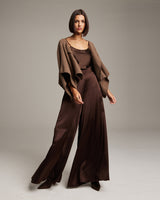 Model wearing a brown bolero over a brown satin outfit