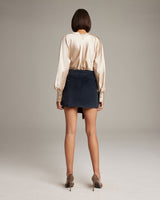 Model wearing the Diamante Mini Wrap Skirt from the back