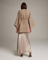 Back view of Flammé Samurai Jacket in beige, worn over a long satin skirt