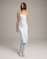 Light blue midi slip dress with spaghetti straps and a flowing silhouette.