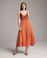 Model wearing an orange Butterfly Wrap Skirt with a satin top