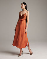Model wearing an orange Butterfly Wrap Skirt with a tie at the waist