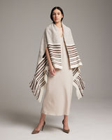 Model wearing the Petite Cascade Wrap in ivory and cafe, showcasing its design and texture.