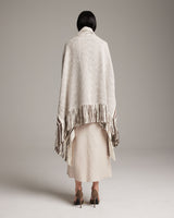 Model wearing a beige Petite Cascade Wrap with fringes from the back