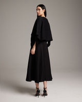 Model wearing a black textured cotton crop top, back view