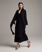 Model wearing a black Linen Featherlight Wrap Blouse with long front sashes