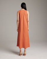 Back view of a linen V neck dress in persimmon color