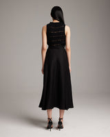 Model wearing a black Longer Flammé Knit Crop Top from the back