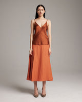 Model wearing a rust V-Neck Silk Cami with a matching skirt