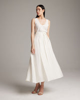 Model wearing a white Butterfly Wrap Skirt, standing in a neutral background.