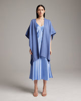 Model wearing a solid cotton duster over a blue slipdress