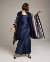 Model wearing a navy and taupe striped zig zag duster over a satin dress