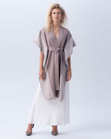 Model wearing a taupe and ivory striped edge caftan, styled with a white skirt.