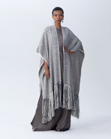 Model wearing a grey and ivory long chevron duster with fringe