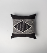 Top view of a black pillow with a diamond pattern in white.