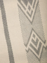Close-up of a Wide Diagonal Alpaca Wrap featuring a geometric pattern in ivory and grey.