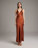 Model wearing a rust-colored Double V Slip Dress in sandwashed silk