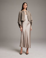 Model wearing a shimmering cotton bolero over a satin dress