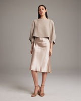 Model wearing a textured cotton crop top with a satin skirt