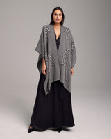 Model wearing a gray Raíz Duster over a black dress