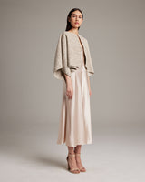 Model wearing a hand-loomed Marble Bolero over a satin dress