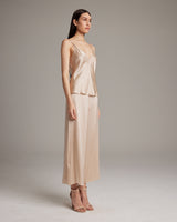 Model wearing a bone-colored V-Neck Silk Cami and culottes, standing sideways.
