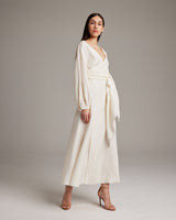 Model wearing a white Peasant Blouse Dress with a wrap silhouette and open neckline