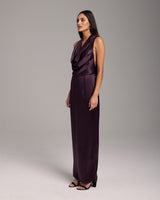 Model wearing a purple convertible halter dress with a cowl neckline