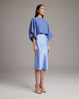 Model wearing a blue textured cotton crop top with a satin skirt