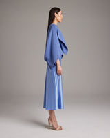 Model wearing a periwinkle textured cotton bolero with a blue satin dress