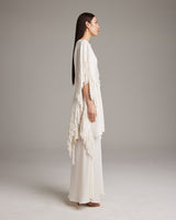 Model wearing a textured cotton fringe kaftan, side view