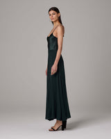 Model wearing a dark green Crinkle Chiffon Double Layer Skirt, side view