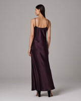 Back view of a model wearing a Liquid Silk Slipdress in aubergine color