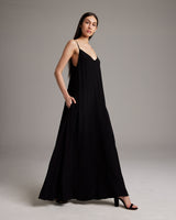 Model wearing a black Parachute Slip Dress with pockets