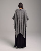 Back view of a black and ivory Raíz Duster with geometric patterns