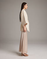 Model wearing an ivory Samurai Jacket with wide sleeves and a detachable belt