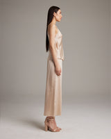 Model wearing a bone-colored V-Neck Silk Cami and culottes, side view.