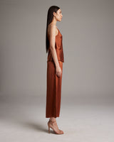 Model wearing a rust V-Neck Silk Cami and culottes, side view