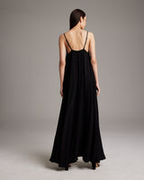 Back view of a model wearing a black Parachute Slip Dress