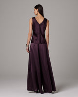 Model wearing a silk palazzo pants and top, back view
