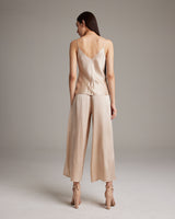 Back view of a model wearing a V-Neck Silk Cami with culottes in bone color