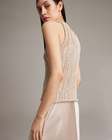 Model wearing a lace knit tank top in pearl color, showing back view.